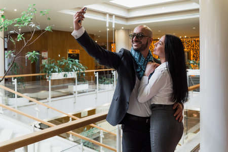 Arab businessman and girl making selfie in the shopping centerの写真素材