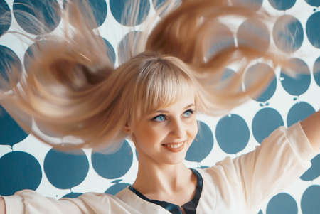 Girl shakes your head and smiles for camera at the beauty salonsの写真素材