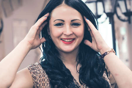 Attractive young woman smiling and looking on camera indoorsの写真素材