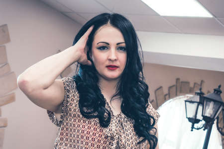 Beautiful model woman posing and looking on camera at coffeehouseの写真素材