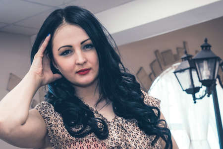 Attractive young woman smiling and looking on camera indoorsの写真素材