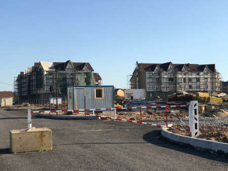 Gate to restrict entrance to the construction site. Construction of multi-storey apartment buildings in the summerの写真素材