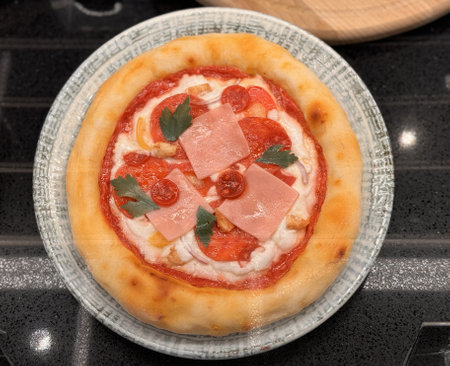 Top view of delicious sliced pizza with cheese and tomatoes on wooden dish on the table at the restaurant. Close-upの写真素材