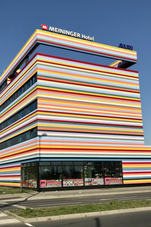 BERLIN, GERMANY - APRIL 20, 2018: The colorful facade of the Meininger Hotel near Berlin Brandenburg Airport in spring season. The building also houses an Aldi supermarketのeditorial素材