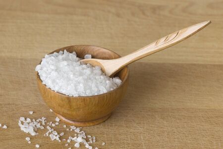 Sea salt in a wooden bowlの写真素材