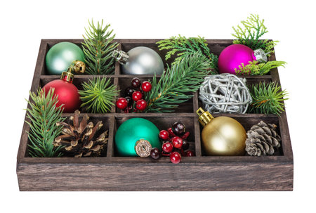 Wooden box with various Christmas decorations on a white backgroundの写真素材