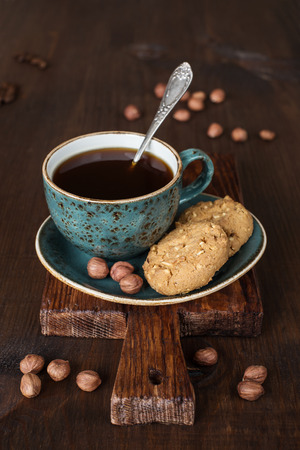 Black coffee in blue vintage cup on old dark cutting boardの写真素材
