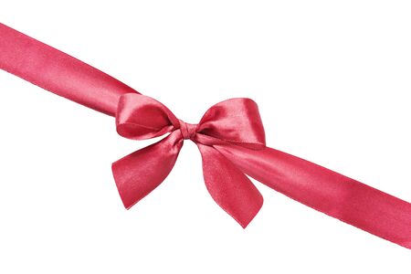 Red silk gift bow on the diagonally red silk ribbon isolated on a white backgroundの写真素材