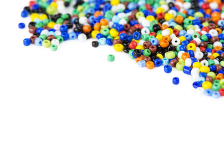 Many multi-colored beads for needlework isolated on a white backgroundの写真素材