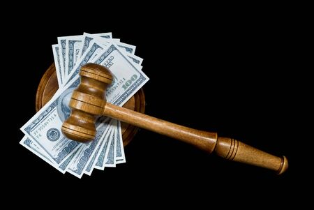 Wood gavel, soundblock and bank notes on a black background. Allegory of the corrupt justiceの写真素材