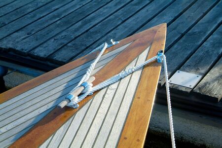 Bow of classic, wooden sailboat with teak-deck