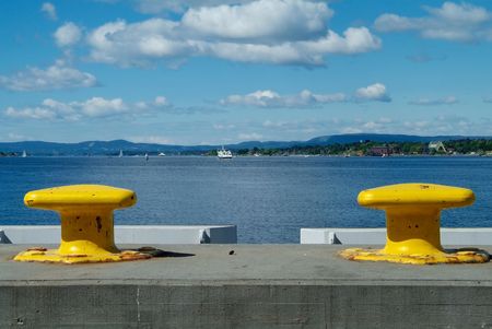 Two yellow cleats with a view over the Oslofjord, Norwayの写真素材