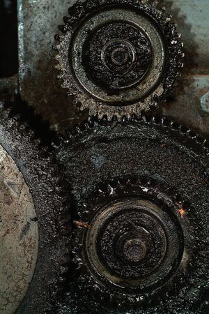 Close-up of old, greasy gears on a machineの写真素材