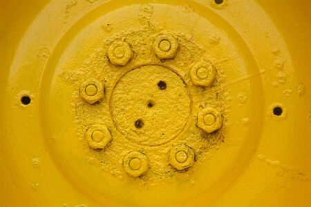 Detail of old, yellow tractor wheelの写真素材