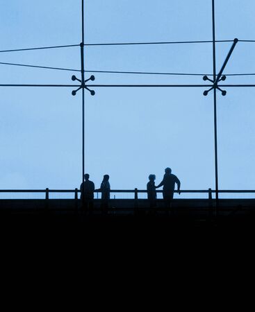 Passengers waiting for their flight in front of large panorama windows at an international airportの写真素材