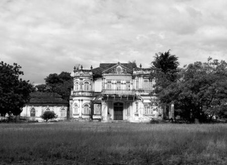 19th century mansion in a big garden, falling apart. Black and white photography.の写真素材