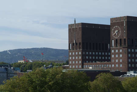 The City Hall of Oslo, Norway, with the Rpyal Palace and Holmenkollen ski-jump in the background.の写真素材