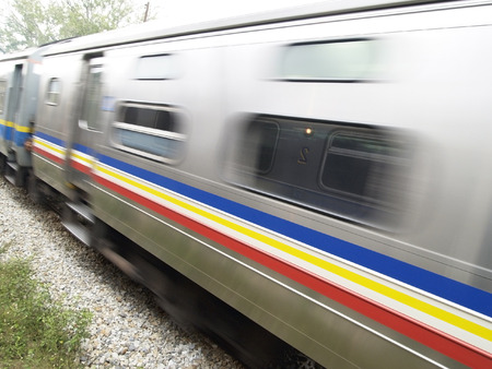 Railway car moving at high speed. Motion blur and reflection of waiting train in the window.