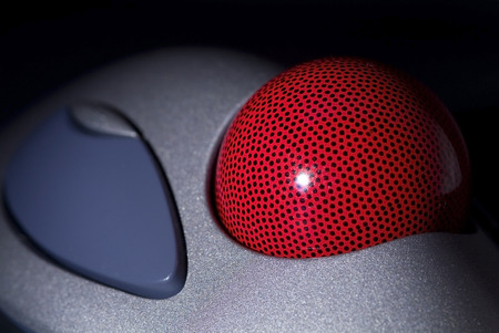 Detail of trackball, a computer pointing device, on black background. Shallow depth of field with only the ball in focus.の写真素材