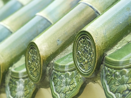 Green, glazed, Chinese roof tiles. Shallow depth of field with the first tile in focus.の写真素材