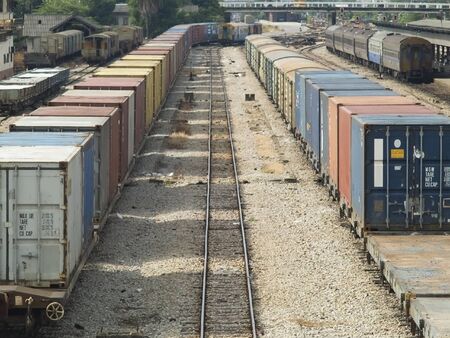 Freight and passenger trains at a railway station in Hat Yai, Thailand