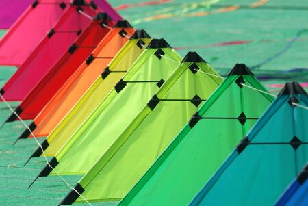 A string of colourful stunt kites on the ground, ready for take-offの写真素材