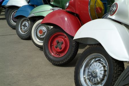 Front wheels of classic, Italians scooters in assorted colours.