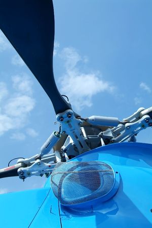 Rotor detail of large, blue helicopter on a blue sky background
