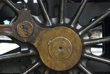 Wheel detail of old steam engine stained by oil used for lubrication.