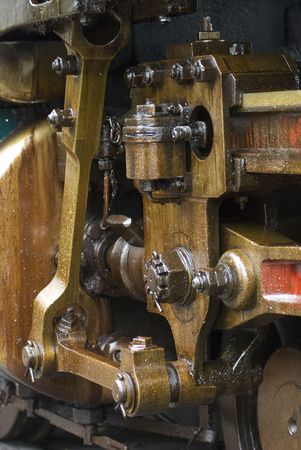 Running gear of old steam engine stained by oil used for lubrication.
