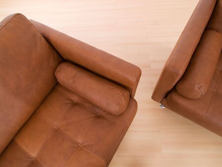 Detail of two brown leather sofa on a parquet floorの写真素材