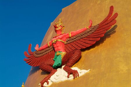 Garuda, the mythical bird, on a Golden Cheddi at a temple in the Samut Prakan province of Thailand.の写真素材