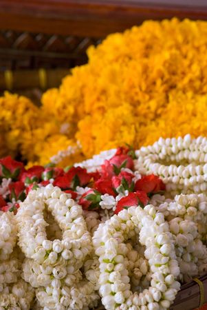 Puang malay, flower garlands at Buddhist temple in Thailand. Shallow depth of field with the nearest garlands in focus.の写真素材