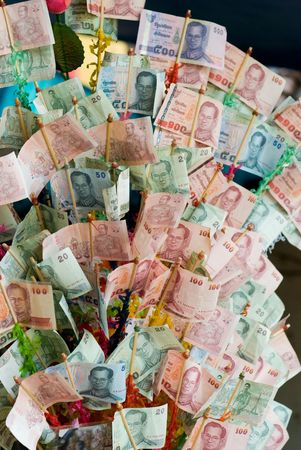 Money tree at Buddhist temple in Thailand consisting of banknotes donated by vistors for maintenance of the temple.の写真素材
