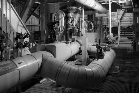 Pipes and valves of industrial cooling system at processing plant. Black and white photo.の写真素材