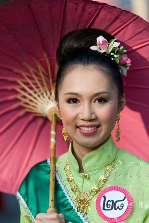 CHIANG MAI, THAILAND - JANUARY 15: Woman in traditional costume during the annual Umbrella festival in Bo Sang, Chiang Mai, Thailand on January 15, 2010, where traditional umbrellas have been made for more than 100 years.のeditorial素材