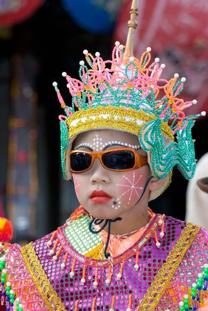 CHIANG MAI, THAILAND - JANUARY 15: Young boy in traditional costume during the annual Umbrella festival in Bo Sang, Chiang Mai, Thailand on January 15, 2010, where traditional umbrellas have been made for more than 100 years.のeditorial素材