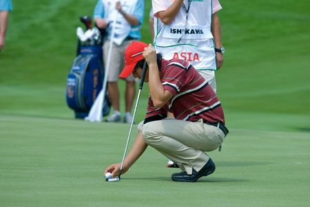 BANGKOK, THAILAND - JANUARY 8: Japanese golf player Ryo Ishikawa preparing a put at the Royal Trophy tournament, Asia vs Europe, at Amata Spring, Bangkok, Thailand on January 8, 2010.のeditorial素材