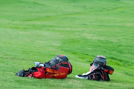 BANGKOK, THAILAND - JANUARY 8: Two golf bags in the grass at the Royal Trophy tournament, Asia vs Europe, at Amata Spring, Bangkok, Thailand on January 8, 2010.のeditorial素材