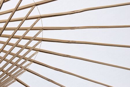 Detail of white wooden umbrella seen from the inside.の写真素材