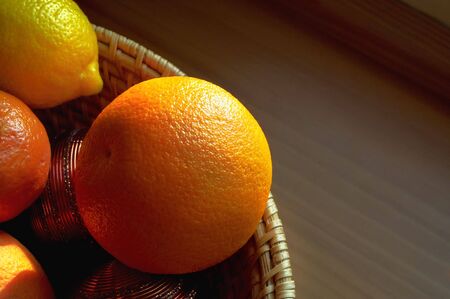 Citrus fruits, orange, lemon and mandarin in a basketの写真素材