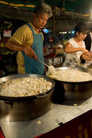 SAMUT PRAKAN - NOVEMBER 7: Man selling soup in an improvised restaurant at Pra Samut Chedi temple fair on November 7, 2010 in Samut Prakan, Thailand.のeditorial素材