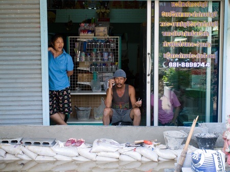 AYUTTAYA, THAILAND - OCTOBER 5: Shop owner building flood barricade from bricks to protect his shop during the monsoon season in Ayuttaya, Thailand on October 5, 2011.のeditorial素材