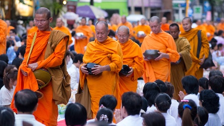 BANGKOK - DECEMBER 23: Monks participating in a mass alms giving in the morning at Soi Thonglor in celebration of the 2,600th anniversary of Lord Buddha's enlightenment on December 23, 2012 in Bangkok, Thailand.のeditorial素材