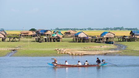 Sittwe Rakhine State Myanmar  October 16 2014: Traditional boat passing a village along the Kaladan River at the Rakhine State in Myanmar.のeditorial素材