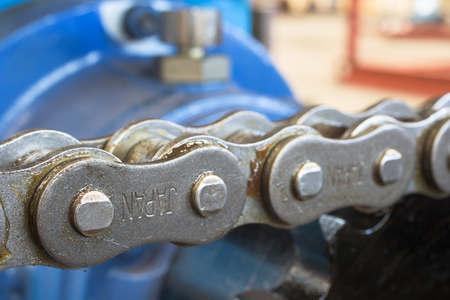 Extreme close-up of chain. Very shallow depth of field with only a part of the nearest chain link in focus.の写真素材
