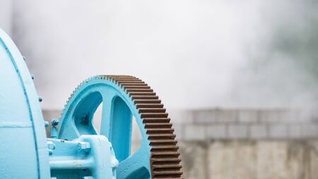 Old industrial dryer with place for text on the out of focus, foggy background. The cogwheel of the dryer in focus.の写真素材