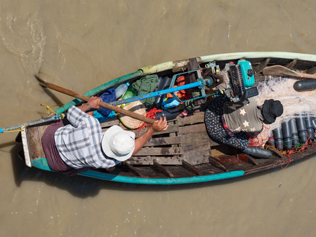 Dala, Myanmar - November 5, 2017: Aerial view of small, traditional fishing vessel with husband and wife team padling down Dala River near Yangon.のeditorial素材