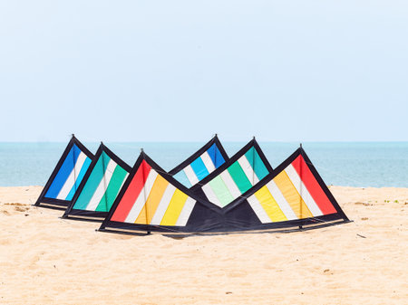 A stack of three quad line sports kites in red, green and blue colours on the beach in Kelantan, Malaysia.の写真素材