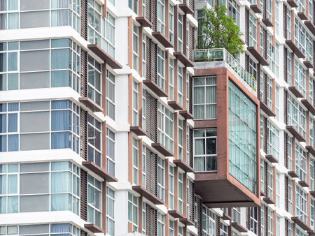 Facade of high rise condominium building in Bang Na on the outskirts of Bangkok, Thailand.の写真素材